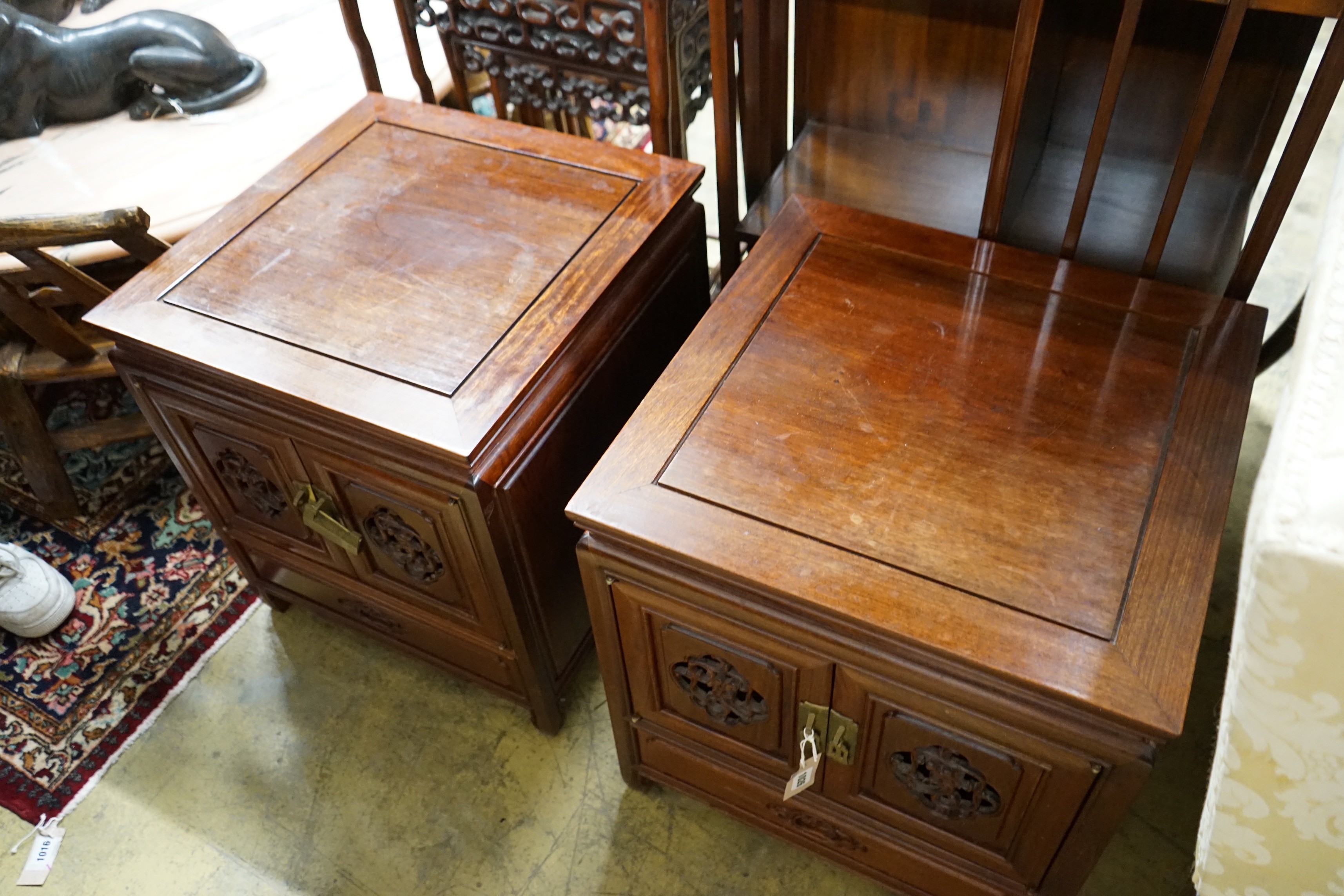 A pair of Chinese carved padouk bedside cabinets, width 51cm, depth 51cm, height 56cm